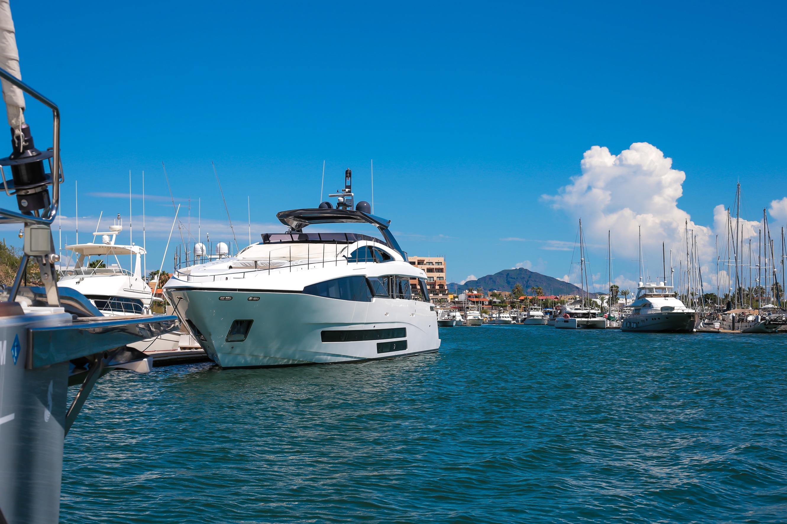 Luxury Bugari F86 yacht docked in a marina, 2021 model.