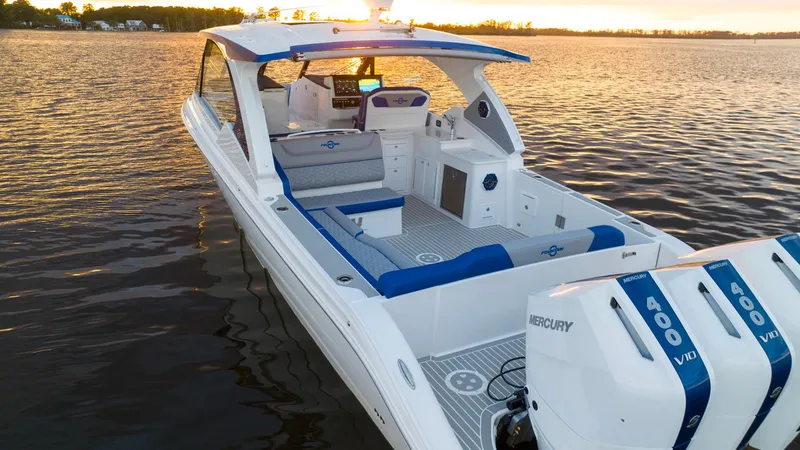 Cortez Cove 39dx Yacht Photos Pics 2025 Fountain 39 DX boat with triple Mercury 400 engines on a serene lake at sunset.