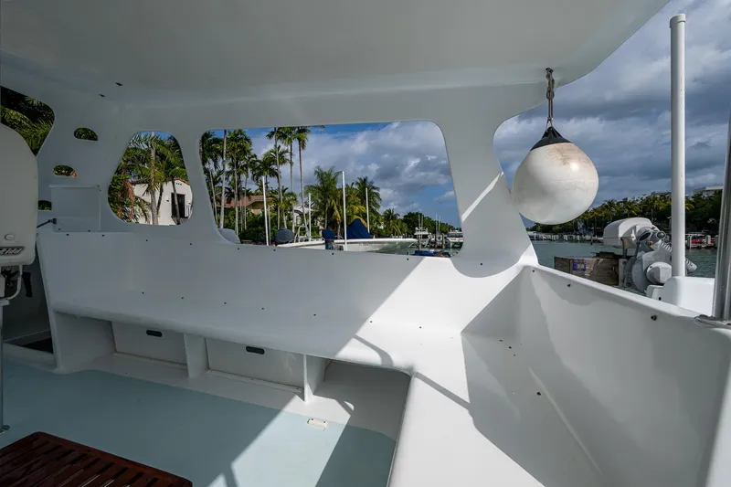  Yacht Photos Pics 2019 Aventura 31 Cat boat interior with white seating and scenic marina view.