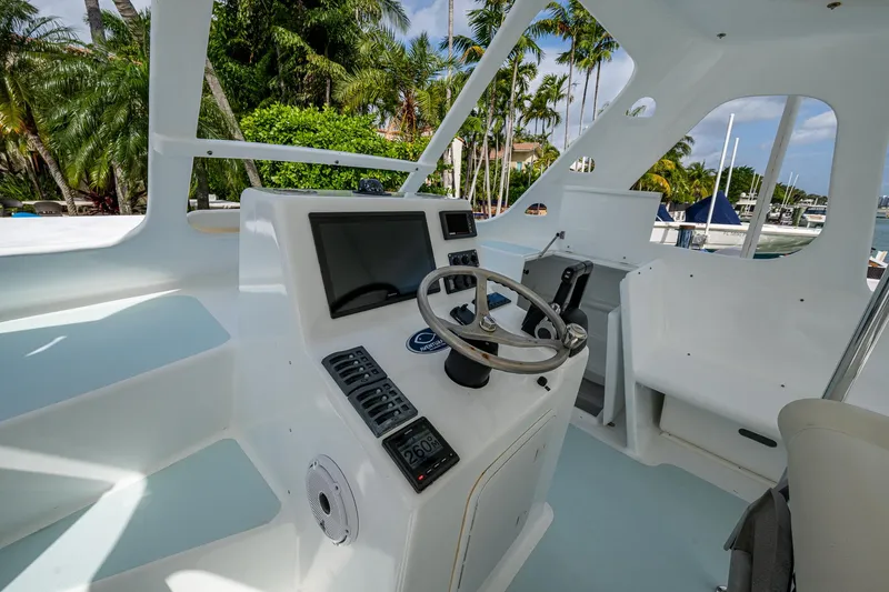  Yacht Photos Pics Aventura 31 Cat 2019 boat cockpit with steering wheel and navigation controls.