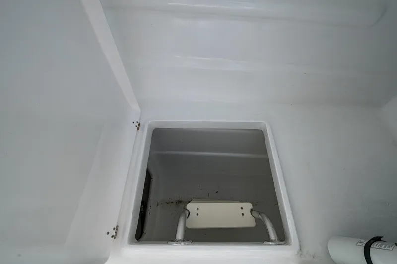  Yacht Photos Pics Storage compartment in 2019 Aventura 31 Cat boat, featuring a clean, white interior.