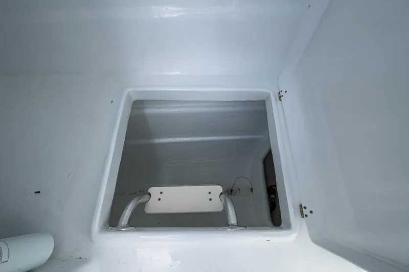  Yacht Photos Pics Interior compartment of 2019 Aventura 31 Cat boat, featuring a storage area with metal handles.