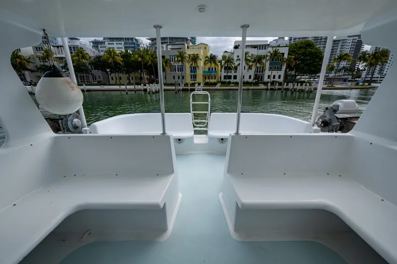  Yacht Photos Pics 2019 Aventura 31 Cat boat interior with waterfront view, featuring white seating and modern design.