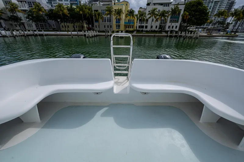  Yacht Photos Pics 2019 Aventura 31 Cat boat with spacious seating, overlooking a serene waterfront view.