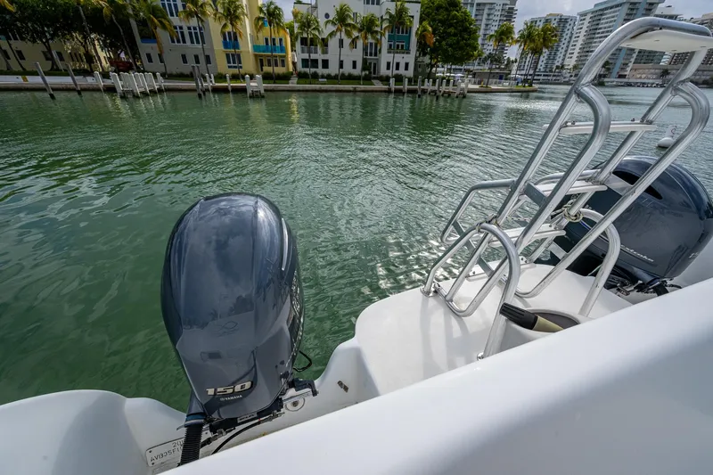 Yacht Photos Pics Aventura 31 Cat 2019 boat with dual outboard motors on a calm waterfront.