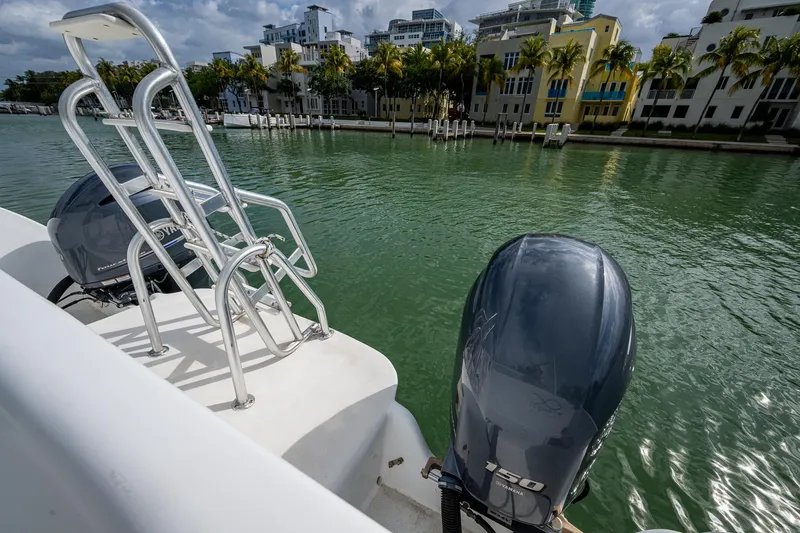  Yacht Photos Pics Aventura 31 Cat 2019 boat with dual engines docked by waterfront buildings.