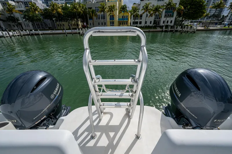  Yacht Photos Pics 2019 Aventura 31 Cat boat with dual Yamaha engines and a rear ladder on a calm waterway.