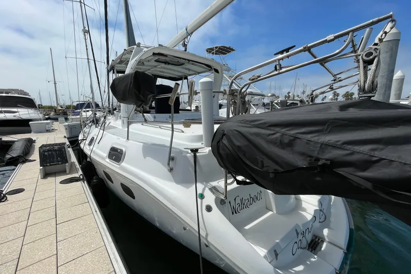  Yacht Photos Pics 1999 Hunter Passage 420 sailboat docked at marina under clear blue sky.