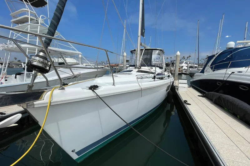  Yacht Photos Pics Sailboat docked in marina, 1999 Hunter Passage 420, clear sky background.