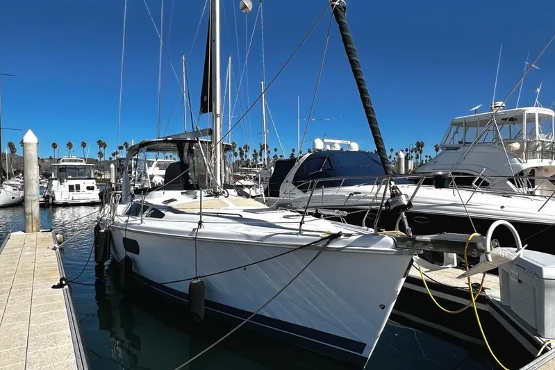  Yacht Photos Pics 1999 Hunter Passage 420 sailboat docked at a marina under clear blue skies.