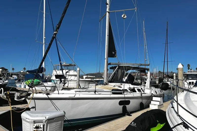  Yacht Photos Pics 1999 Hunter Passage 420 sailboat docked at a marina under clear blue skies.