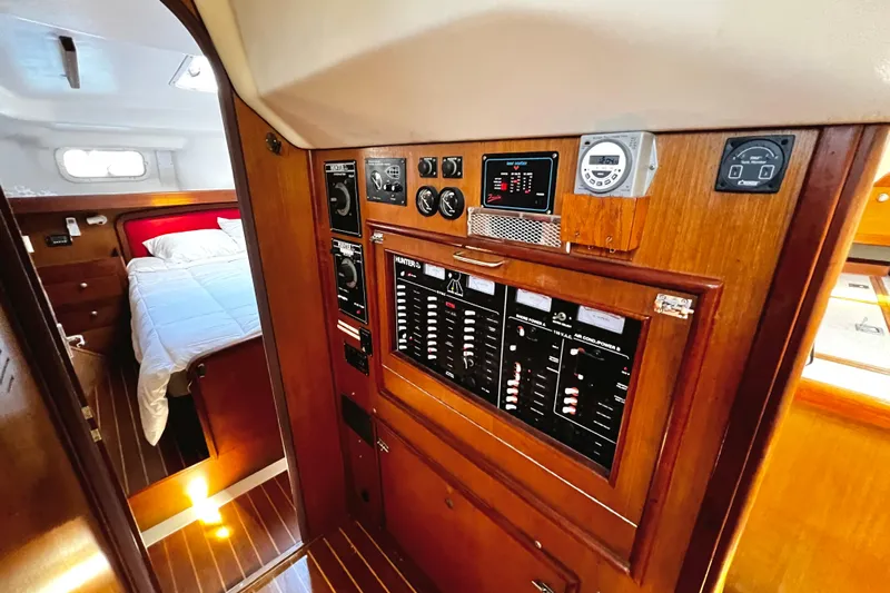  Yacht Photos Pics Interior of 1999 Hunter Passage 420 yacht with control panel and cozy bedroom.