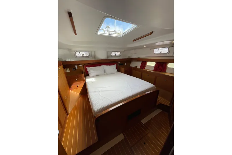  Yacht Photos Pics Cozy cabin interior of 1999 Hunter Passage 420 sailboat with skylight and wood finish.