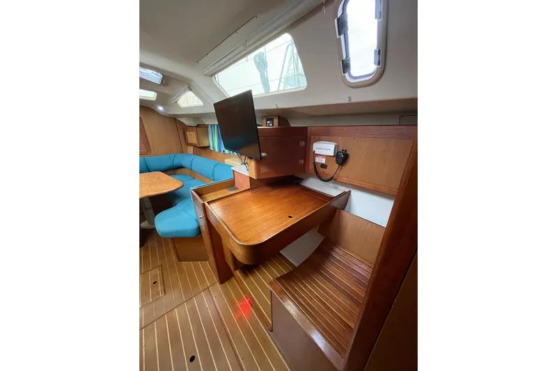  Yacht Photos Pics Interior of 1999 Hunter Passage 420 sailboat with wood finish and blue seating.