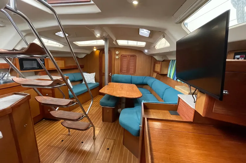 Yacht Photos Pics Interior of 1999 Hunter Passage 420 yacht with wooden finish and blue seating.