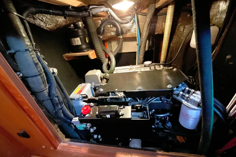  Yacht Photos Pics Engine compartment of a 1999 Hunter Passage 420 sailboat, featuring various mechanical components.