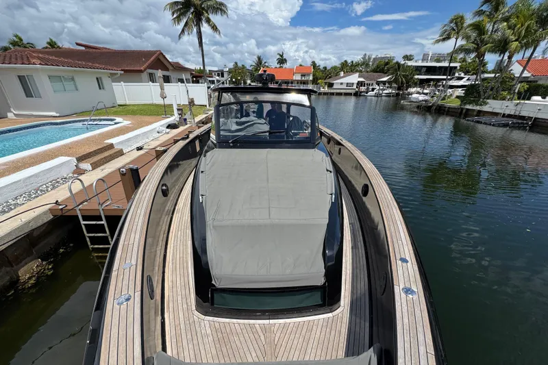  Yacht Photos Pics 2020 Pardo Yachts 50 docked by a canal with palm trees and houses.
