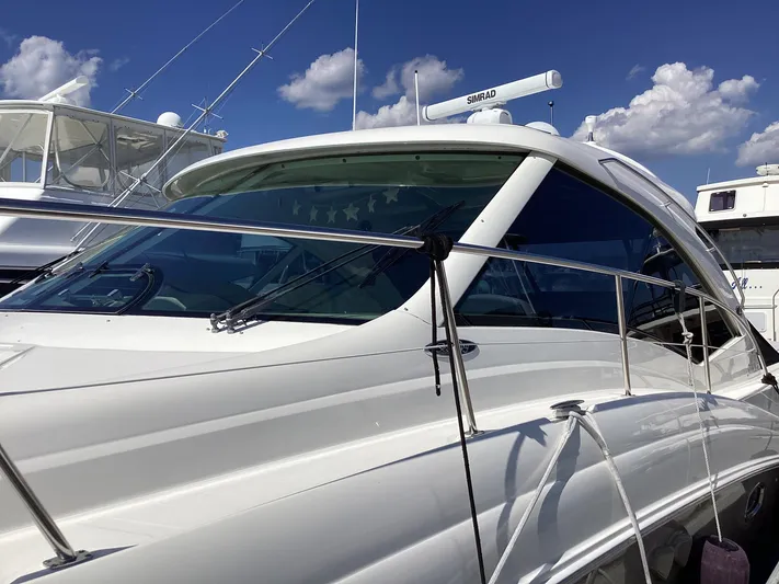  Yacht Photos Pics 2006 Sea Ray 48 Sundancer yacht with sleek design, docked under a clear blue sky.