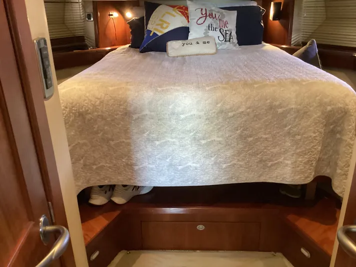 Yacht Photos Pics Cozy bedroom interior of 2006 Sea Ray 48 Sundancer yacht with decorative pillows.