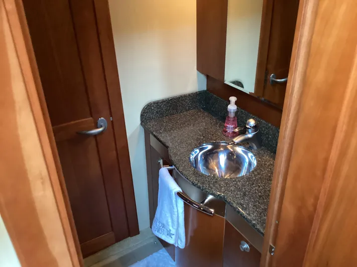  Yacht Photos Pics Bathroom interior of 2006 Sea Ray 48 Sundancer yacht with wooden cabinetry and stainless steel sink.