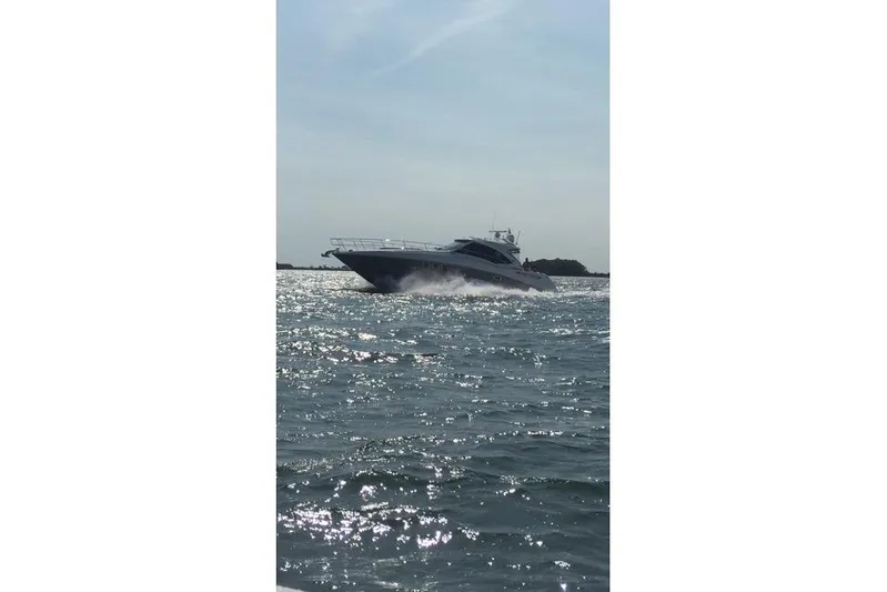  Yacht Photos Pics 2006 Sea Ray 48 Sundancer cruising on open water under a clear sky.