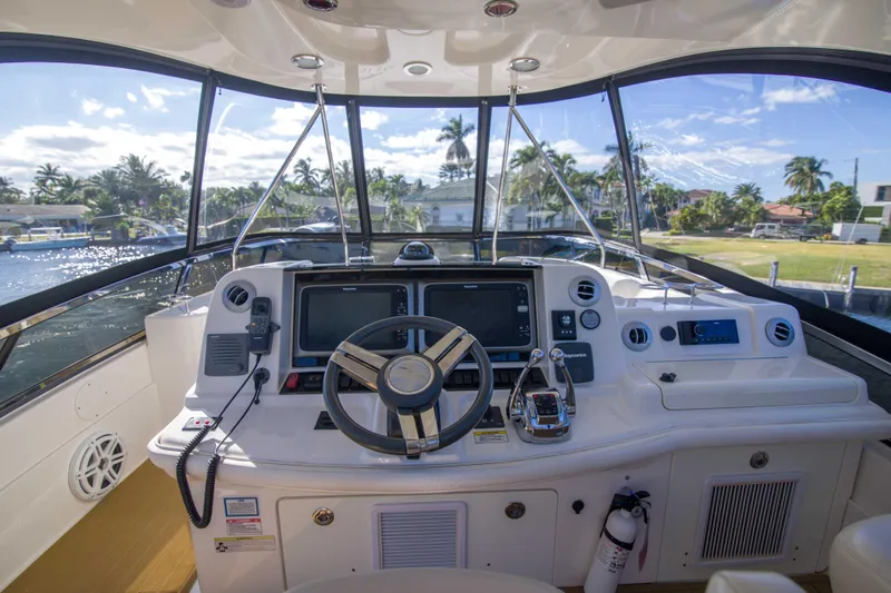 Exodus Yacht Photos Pics Helm of 2013 Sea Ray 520 Sedan Bridge with modern navigation equipment and scenic view.