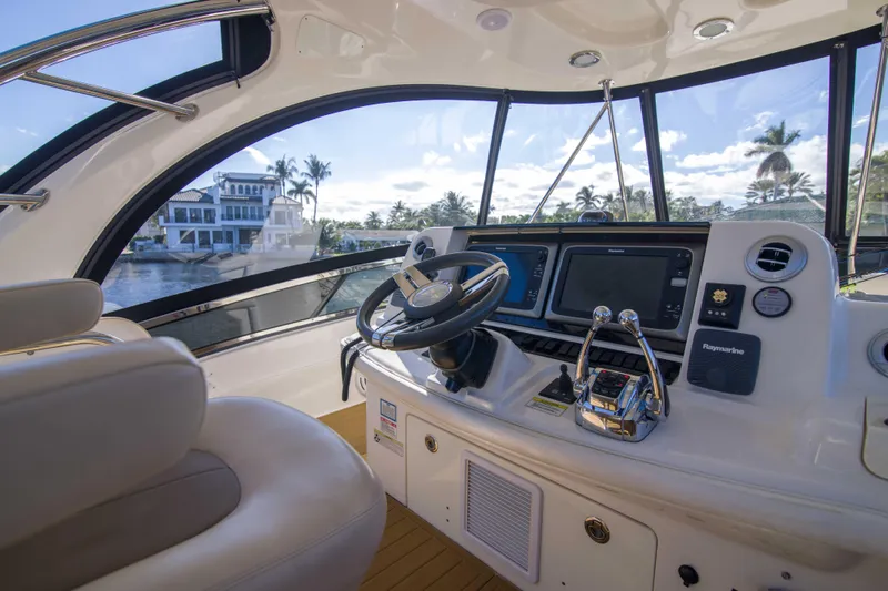 Exodus Yacht Photos Pics 2013 Sea Ray 520 Sedan Bridge helm with modern navigation equipment and waterfront view.