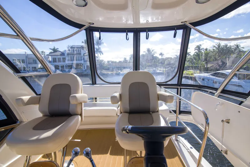 Exodus Yacht Photos Pics Interior view of 2013 Sea Ray 520 Sedan Bridge yacht with luxurious seating and panoramic windows.