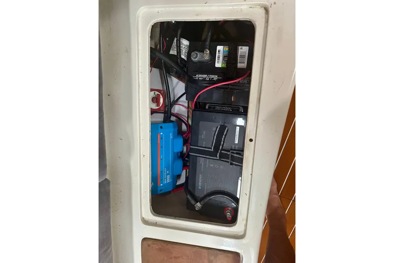 Makai Yacht Photos Pics Electrical components inside a 1999 Catalina 320 boat, featuring batteries and wiring.