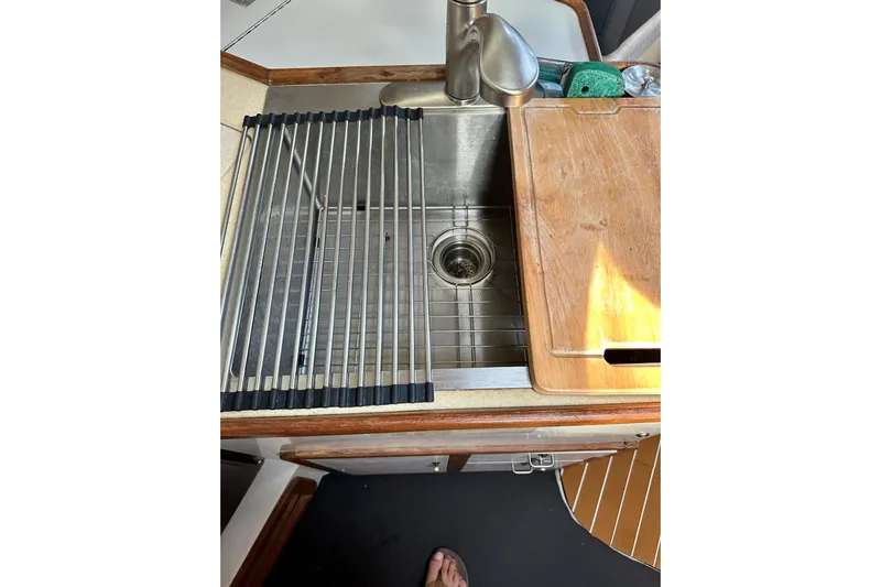 Makai Yacht Photos Pics Stainless steel sink with cutting board in 1999 Catalina 320 yacht kitchen.