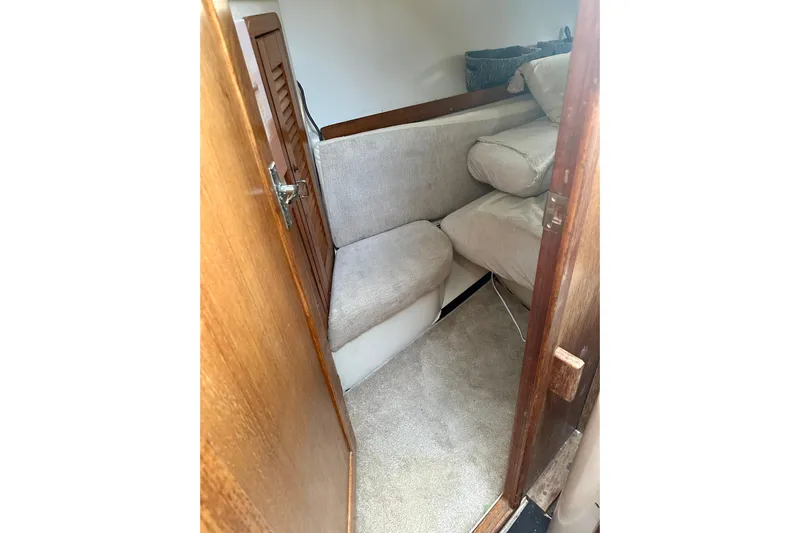 Makai Yacht Photos Pics Cozy interior cabin of 1999 Catalina 320 sailboat with cushioned seating.