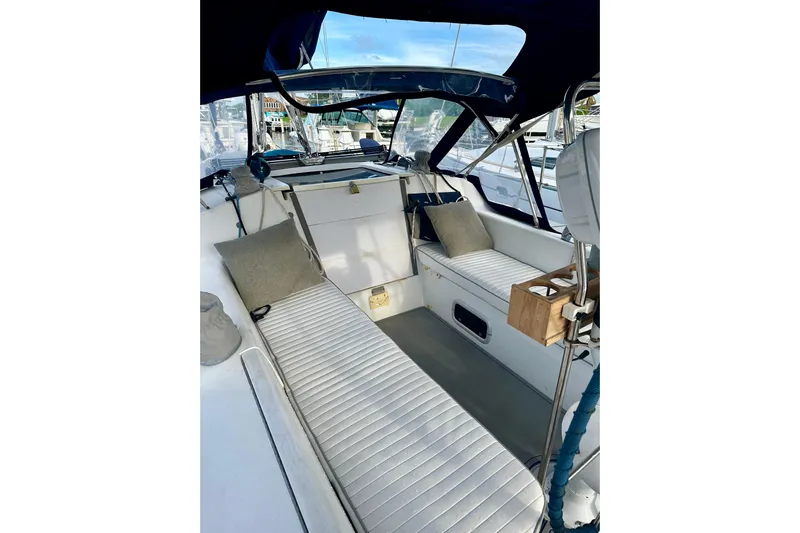 Makai Yacht Photos Pics Interior view of a 1999 Catalina 320 sailboat cockpit with cushioned seating.