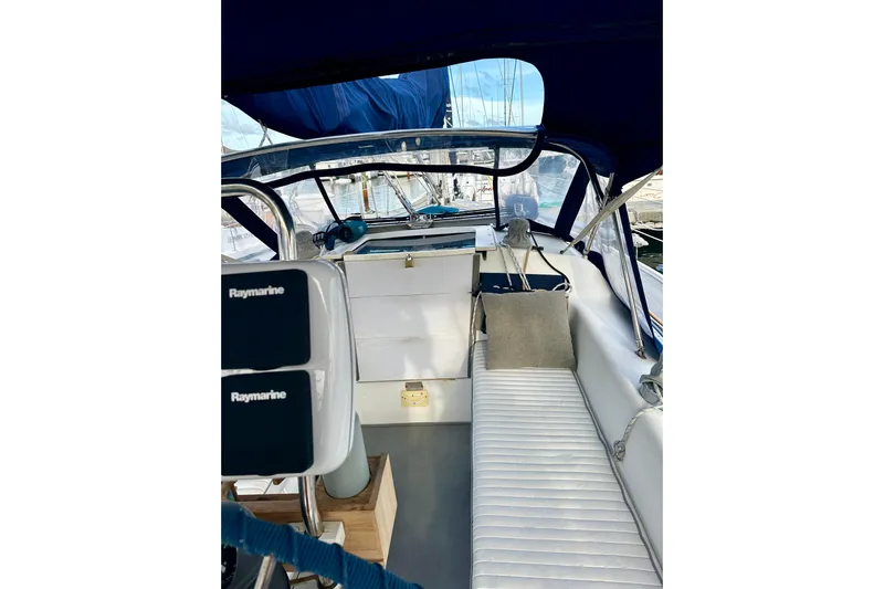 Makai Yacht Photos Pics 1999 Catalina 320 sailboat cockpit with Raymarine equipment and cushioned seating.