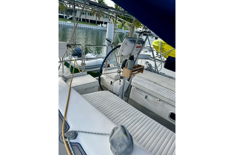 Makai Yacht Photos Pics 1999 Catalina 320 sailboat interior with white seating, docked by calm waters.