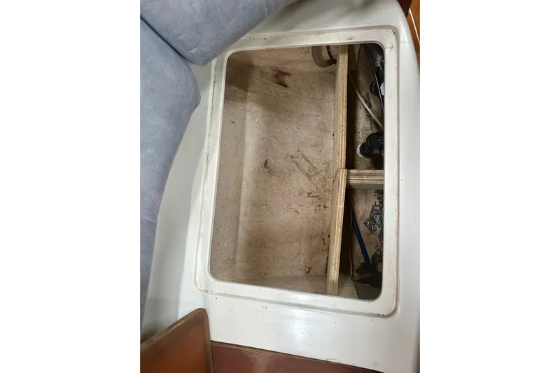 Makai Yacht Photos Pics Open storage compartment on a 1999 Catalina 320 sailboat, showing interior details.