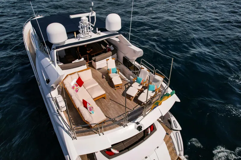 El Tio Yacht Photos Pics Sunseeker 90 Yacht 2006, luxurious deck view, ocean backdrop, elegant seating arrangement.