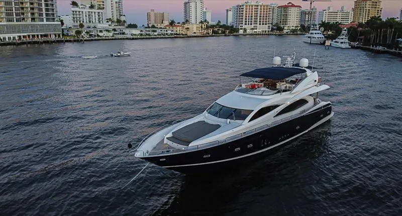 El Tio Yacht Photos Pics 2006 Sunseeker 90 Yacht cruising in a city harbor at sunset.