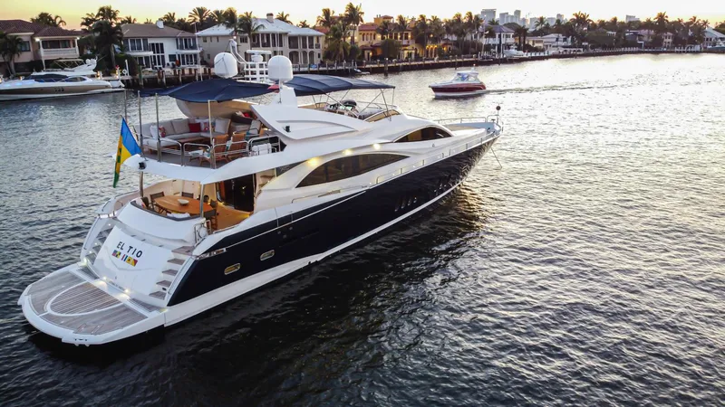 El Tio Yacht Photos Pics Luxurious 2006 Sunseeker 90 Yacht cruising on serene waters at sunset.