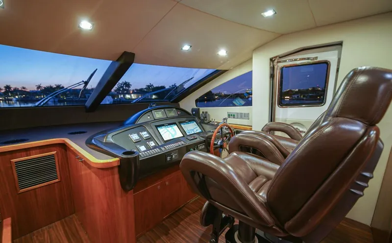 El Tio Yacht Photos Pics Luxurious helm of 2006 Sunseeker 90 Yacht with leather seating and advanced navigation controls.