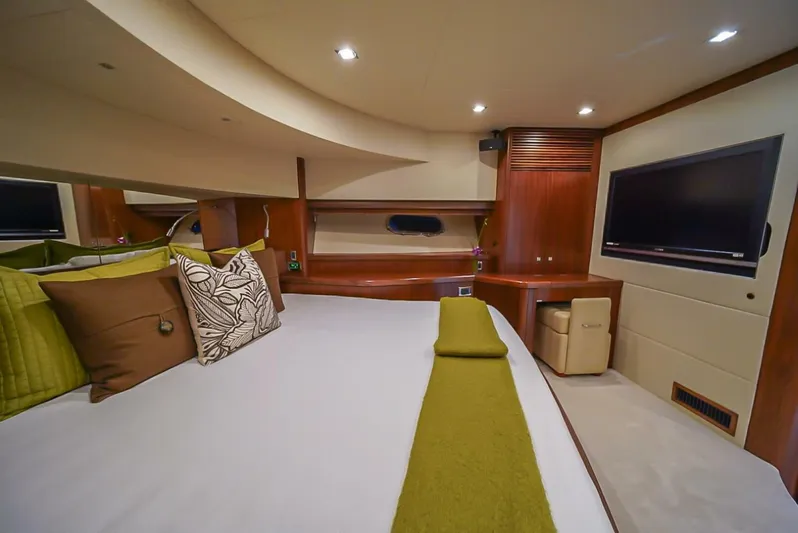 El Tio Yacht Photos Pics Luxurious bedroom interior of 2006 Sunseeker 90 Yacht with modern decor and TV.