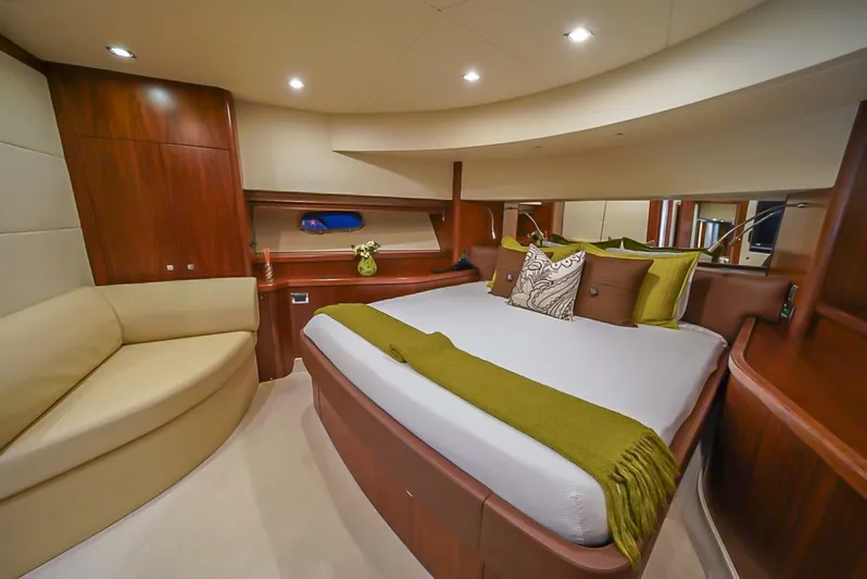 El Tio Yacht Photos Pics Luxurious bedroom interior of 2006 Sunseeker 90 Yacht with elegant wood finish.