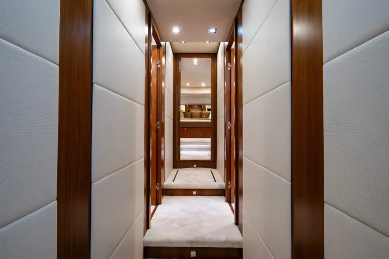 El Tio Yacht Photos Pics Interior hallway of 2006 Sunseeker 90 Yacht with elegant wood paneling and soft lighting.