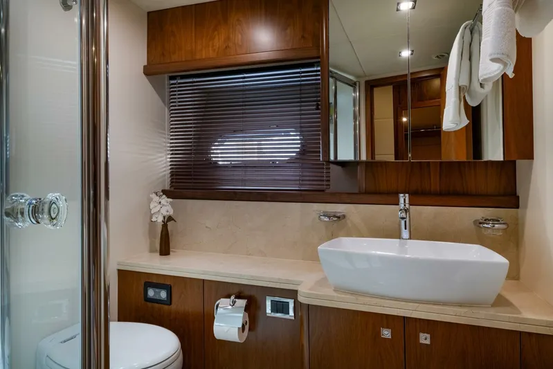 El Tio Yacht Photos Pics Luxurious bathroom in a 2006 Sunseeker 90 Yacht with modern fixtures and wooden accents.
