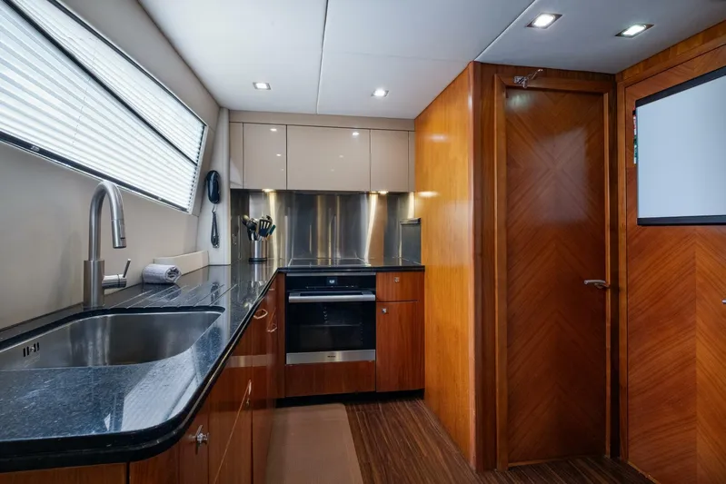 El Tio Yacht Photos Pics Luxurious kitchen interior of 2006 Sunseeker 90 Yacht with modern appliances and wood finishes.