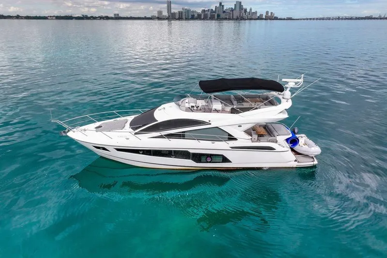 Ohana Forever Yacht Photos Pics 2016 Sunseeker Manhattan 55 yacht on calm blue waters with city skyline.
