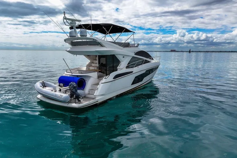 Ohana Forever Yacht Photos Pics 2016 Sunseeker Manhattan 55 yacht on calm ocean waters under cloudy sky.