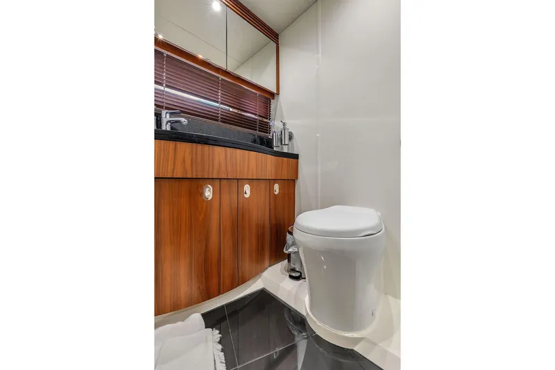 Ohana Forever Yacht Photos Pics Luxury bathroom in 2016 Sunseeker Manhattan 55 yacht with modern fixtures and wood cabinetry.