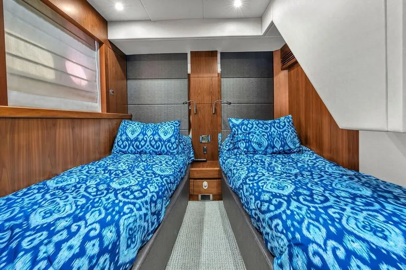 Ohana Forever Yacht Photos Pics Luxurious twin cabin in 2016 Sunseeker Manhattan 55 yacht with blue patterned bedding.