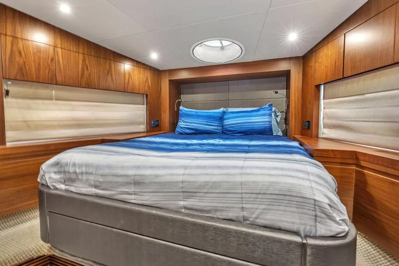 Ohana Forever Yacht Photos Pics Luxurious cabin interior of 2016 Sunseeker Manhattan 55 yacht with wood paneling and cozy bedding.