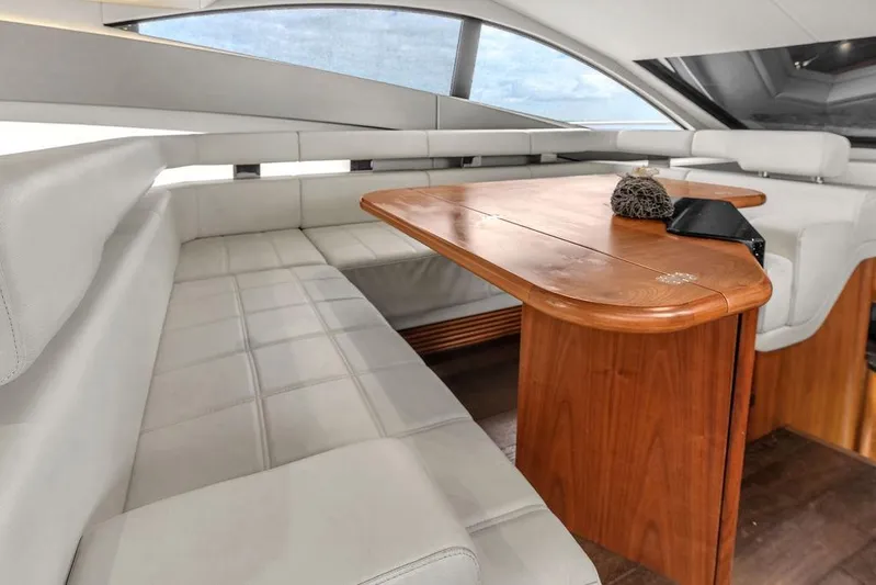 Ohana Forever Yacht Photos Pics Luxurious interior of 2016 Sunseeker Manhattan 55 yacht with elegant seating and wooden table.
